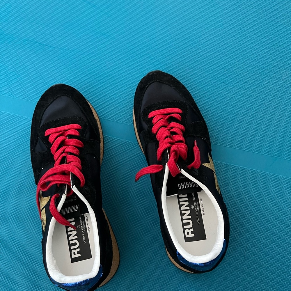 Brand new, never worn Golden goose back/ gold running shoe. Red laces